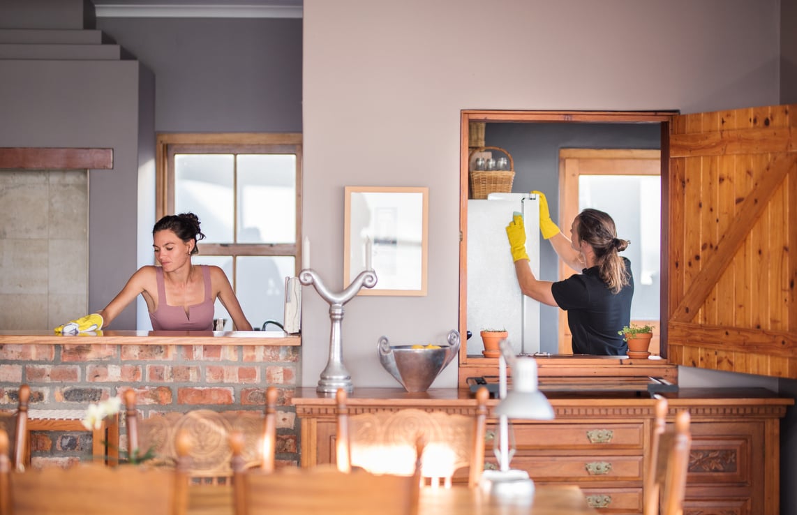 Couple deep-cleaning with rubber gloves